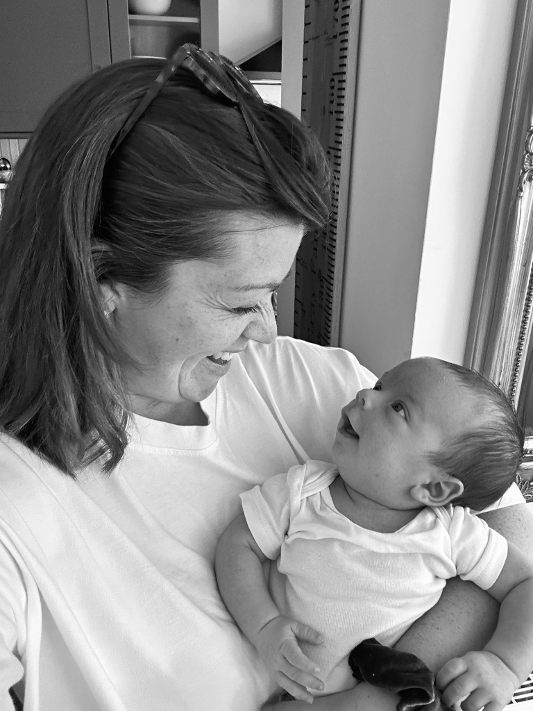 Grace Gray postnatal doula Bath looking lovingly at newborn baby