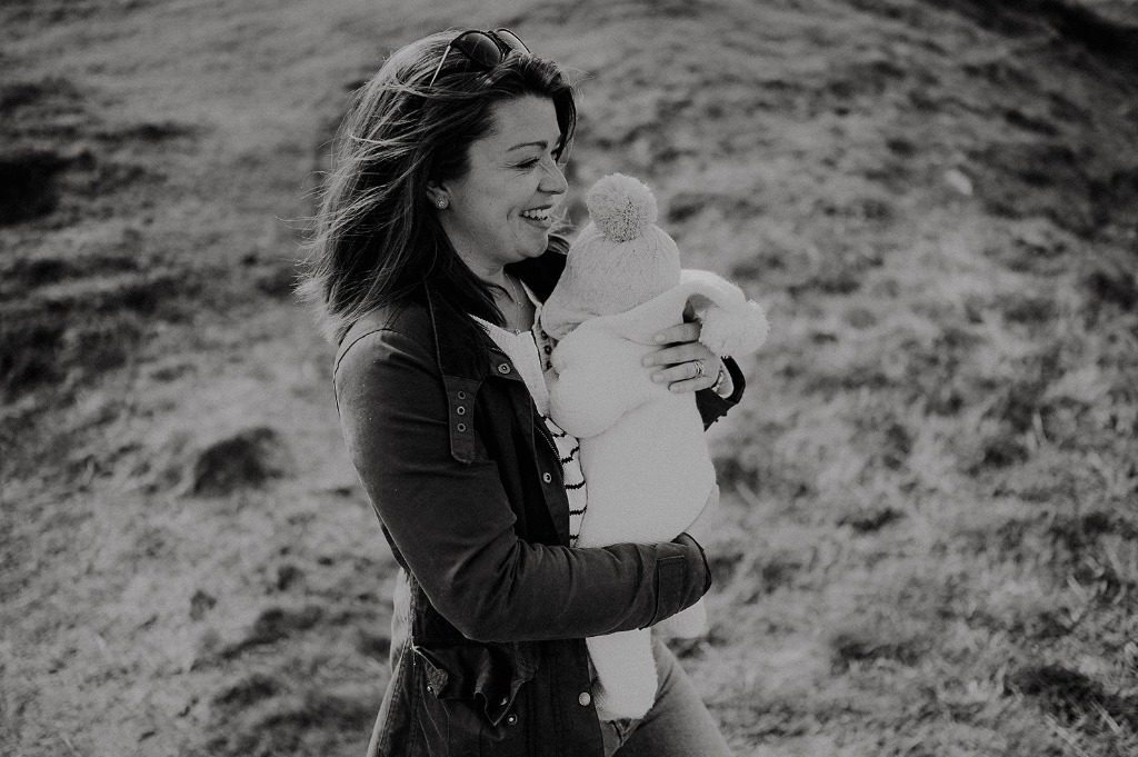 Grace Gray with baby outdoors in Bath countryside